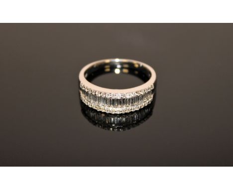 An 18ct white gold diamond half eternity ring, size R/S.