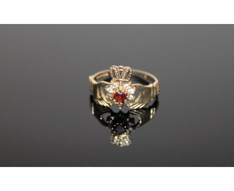 A 9ct gold garnet set Claddagh ring