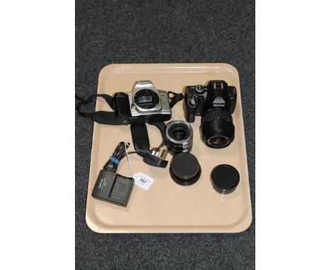 A Pentax K-r digital camera with a Sigma Zoom 28-80mm lens, together with a Pentax MZ-60 camera, a Pentax D-BC2 battery charg