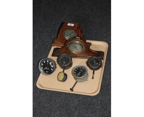 A tray containing two early 20th century oak mantel clocks, Jaeger clocks, Jaeger speedometer etc