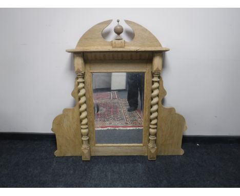 An antique light oak mirror with spiral supports 
