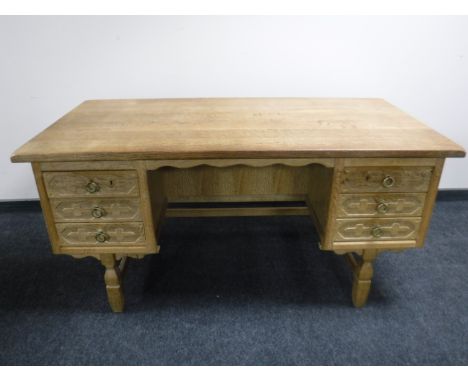 A light oak pedestal desk fitted with six drawers 