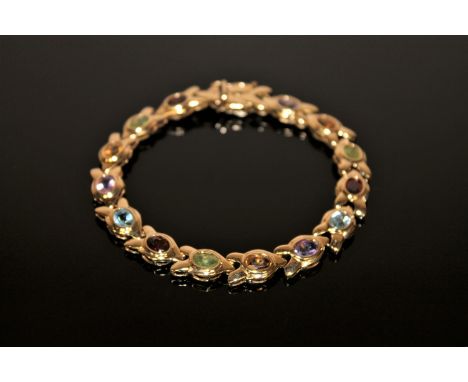 A 9ct gold bracelet set with amethyst, citrine, topaz, peridot etc, 19.9g.