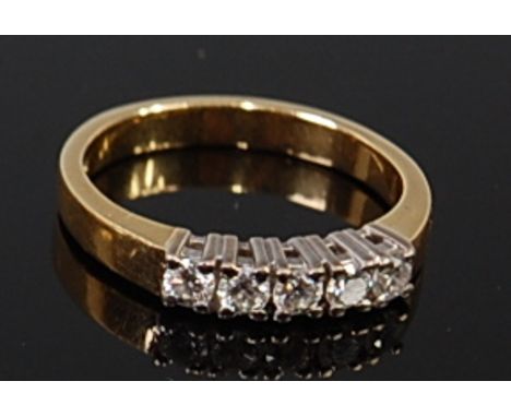 An 18ct gold diamond five stone ring, the claw set brilliants in a line setting, total diamond weight estimated at 0.4ct, 3.8