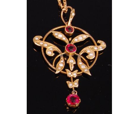 A 1920s 9ct gold, garnet and seed pearl set openwork pendant, 4.3cm (excluding fitting) and on 9ct gold fine belcher link nec