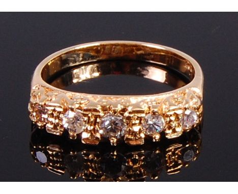 An 18ct gold and diamond set five stone ring, the graduated brilliants in a carved setting, the centre stone weighing approx 