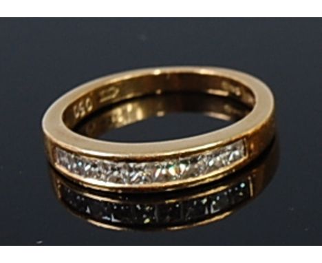 An 18ct gold and diamond half eternity ring, arranged as nine channel set princess cut diamonds, total diamond weight estimat