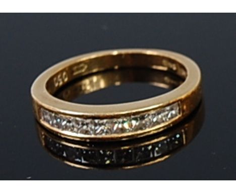 An 18ct gold and diamond half eternity ring, arranged as nine channel set princess cut diamonds, total diamond weight estimat