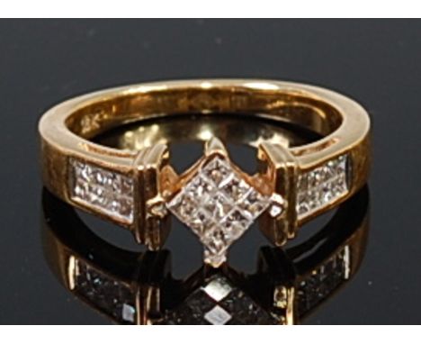 An 18ct gold diamond ring, the centre lozenge set with three rows of small square cut diamonds, the shoulders channel set wit