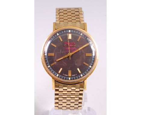 A gents Bulova Accutron gilt metal and steel cased wristwatch, having signed black dial and quartz movement, the hands adjust