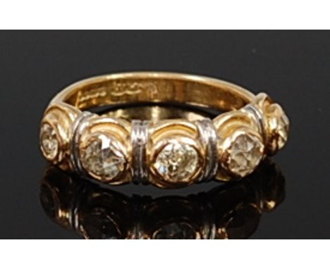 An 18ct gold diamond half eternity ring, arranged as five illusion set old cut diamonds, total diamond weight estimated at ap