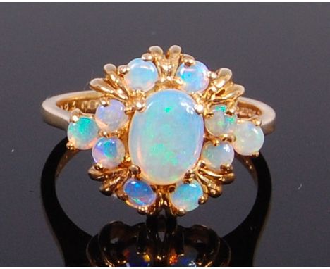 A modern 9ct gold and cabochon opal set flower head cluster ring, 4.5g, size P/Q