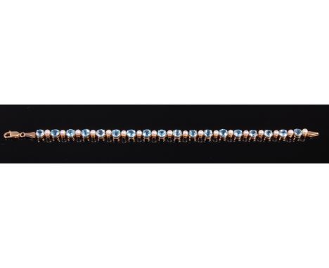A modern 9ct gold, blue topaz and seed pearl set bracelet, 6.8g, each topaz dia. 5mm, length 18cm