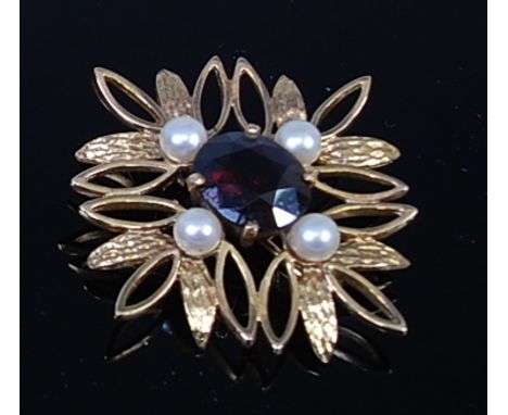 A modern 9ct gold, garnet and cultured pearl set brooch, of flower head design, 8.9g, dia. 4cm