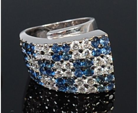 A high carat white gold, sapphire and diamond set dress ring, of chessboard design with alternating sections of four round cu