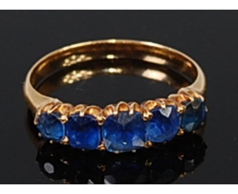 An 18ct gold sapphire five stone ring, the cushion and old cut claw set sapphires in a line setting, 2.7g, size M   Condition