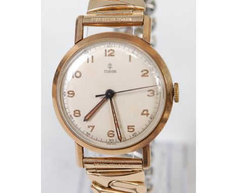 A gents vintage 9ct gold cased Tudor wristwatch, having signed champagne dial, luminous Arabic numerals, and manual wind move