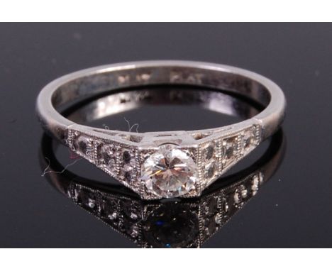 A platinum diamond solitaire ring, the four claw set brilliant weighing approx 0.22ct, 3.8g, size O