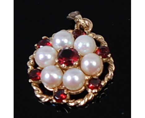 A modern 9ct gold, garnet and cultured pearl set flower head pendant, 3.2g, dia. 1.6cm