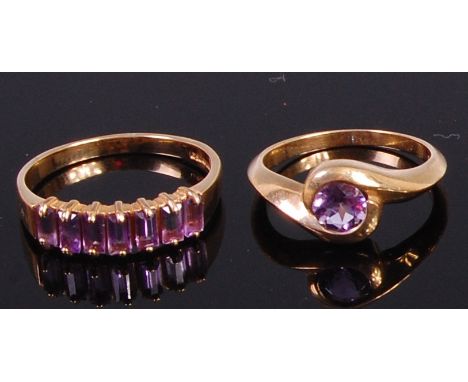 A modern 9ct gold and amethyst set dress ring having a centre round cut amethyst, size K, together with one other 9ct gold an