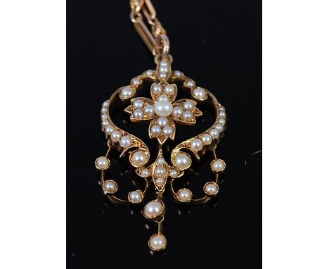 An Edwardian 15ct gold and seed pearl set openwork pendant, 4cm (excluding bale), on 9ct gold neck chain, gross weight 11.8g 