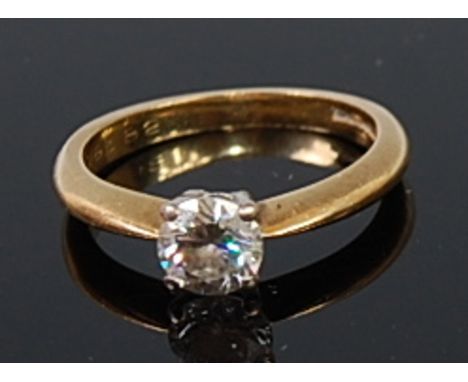 An 18ct gold diamond solitaire ring, the four claw set brilliant weighing approx 0.6ct, 2.5g, size J