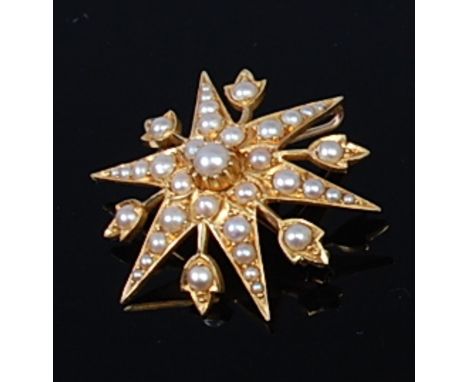 An early 20th century 18ct gold and seed pearl set snowflake brooch, 7.1g, dia. 3.4cm