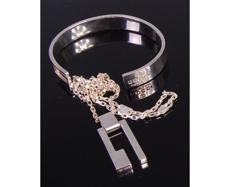 A Modernist Gucci white metal pendant on neck chain; together with a Gucci white metal bangle (2) 