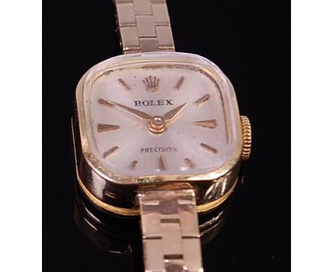 A ladies Rolex 18ct gold cased cocktail watch having a signed silvered dial, baton markers, manual wind movement and on 9ct g