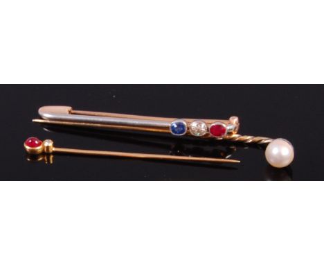 An early 20th century 14ct gold and platinum faced safety pin brooch, set with a single oval cut ruby, diamond and sapphire, 