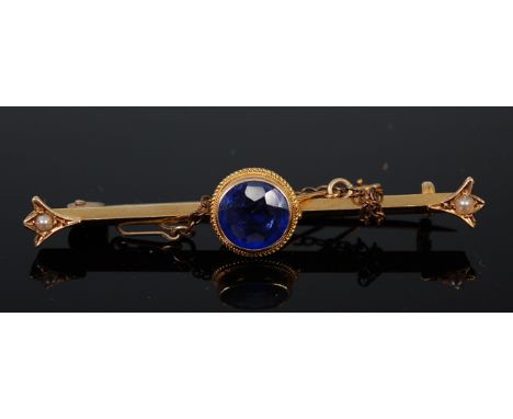 A 15ct gold, synthetic sapphire and seed pearl set knife-edge bar brooch, the centre stone weighing approx 2ct, with safety c