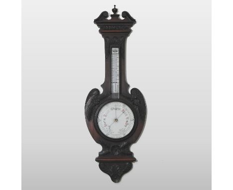 An early 20th century mahogany cased aneroid barometer, with a swan neck pediment and floral carved decoration, 99cm high