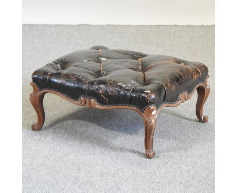 A leather button upholstered footstool, on cabriole legs, 66cm
