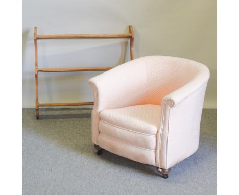 A 1920's pink upholstered tub armchair, together with a hanging pine wall shelf, 95cm