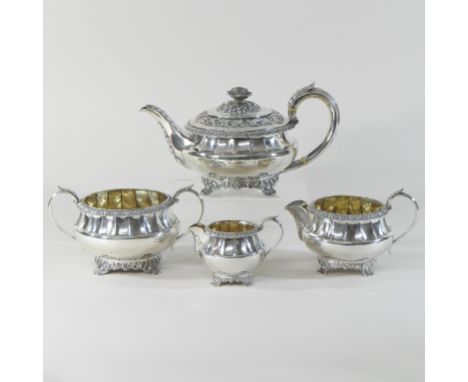 A Victorian matched four piece silver tea service, each of circular faceted shape, with vine and stiff leaf decoration, compr