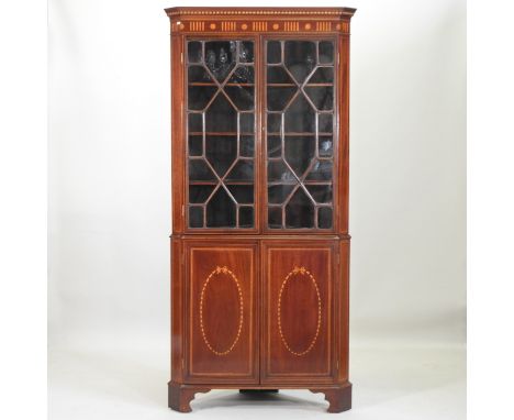 An Edwardian inlaid mahogany astragal glazed corner cabinet, with cupboards below, on bracket feet, 93cm