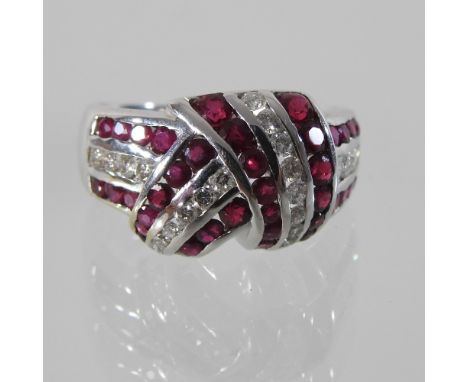 An 18 carat white gold ruby and diamond ring, boxed