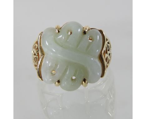 A 9 carat gold carved jade ring, boxed