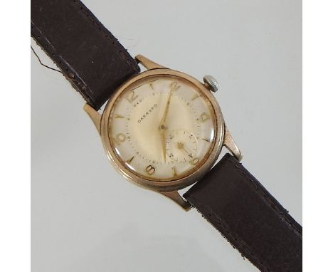 A vintage Garrard 9 carat gold cased gentleman's wristwatch, on a leather strap, in original fitted case inscribed Ford (moto