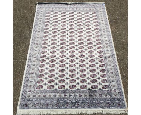 A Bokhara style carpet, with all over design, on a beige ground, 300 x 200cm