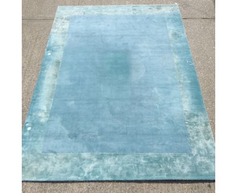 A modern silk and woollen carpet, on a blue ground, 496 x 304cm