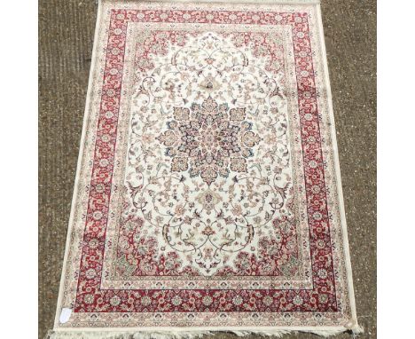 A Keshan style carpet, with scrolled designs, on a beige ground, 230 x 160cm