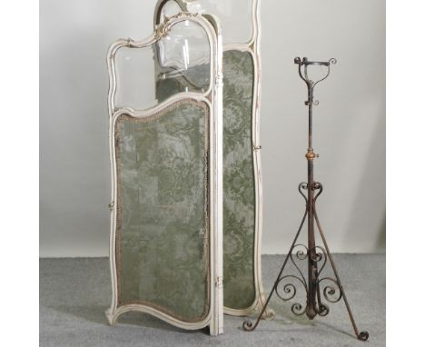 A 19th century cream painted folding dressing screen, together with a black painted wrought iron standard oil lamp