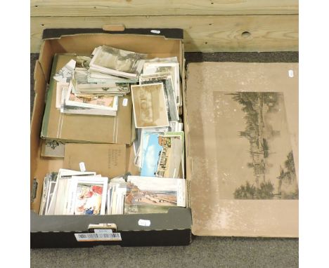 A collection of vintage postcards, together with a print