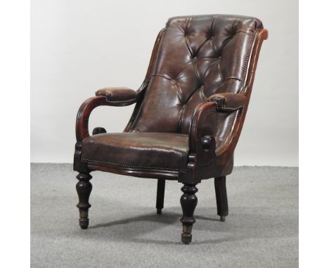 A Victorian brown upholstered button back armchair