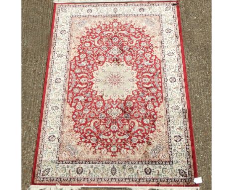 A Keshan style carpet, on a red ground, 230 x 160cm