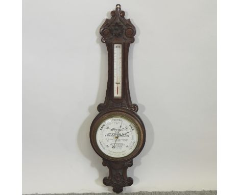 An early 20th century carved oak Harry Hall advertising barometer, 87cm high
