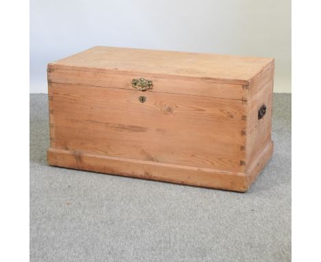 An antique pine trunk, with a hinged lid, 91cm