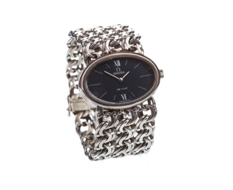 LADY'S SILVER OMEGA DE VILLE SILVER MANUAL WIND WRIST WATCH, the oval dark blue dial with baton hour markers in white, 12 and