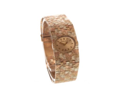 LADY'S BUECHE GIROD&nbsp;NINE CARAT GOLD MANUAL WIND WRIST WATCH, signed movement, the oval gold coloured dial with applied b